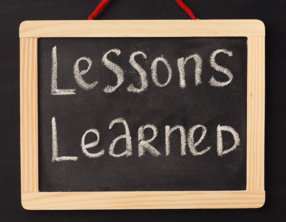 Word lessons learned written on miniature chalkboard in classroom against black background. Back to school concept. Educational background - Lessons Learned - Miller on the Money