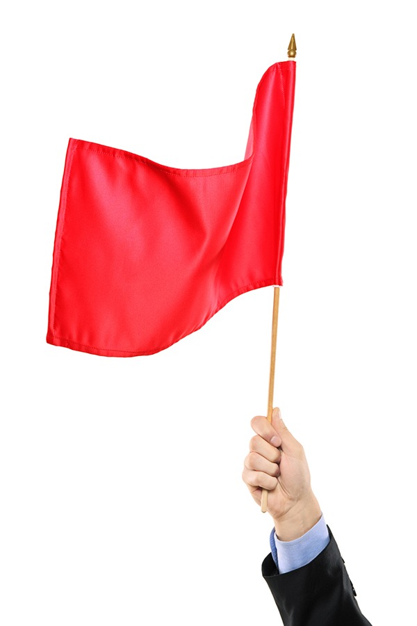 Hand waving a red flag isolated on white background